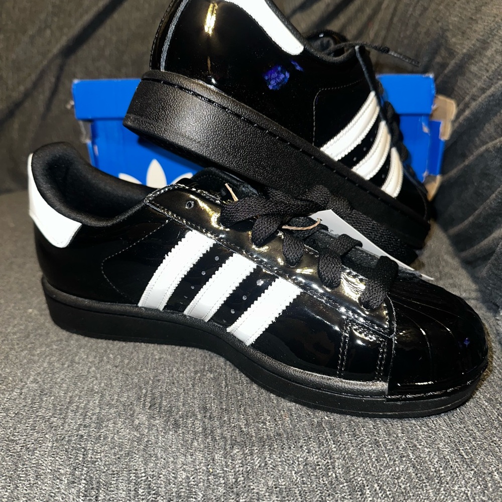 adidas women’s Black and White Patent Leather Sneakers